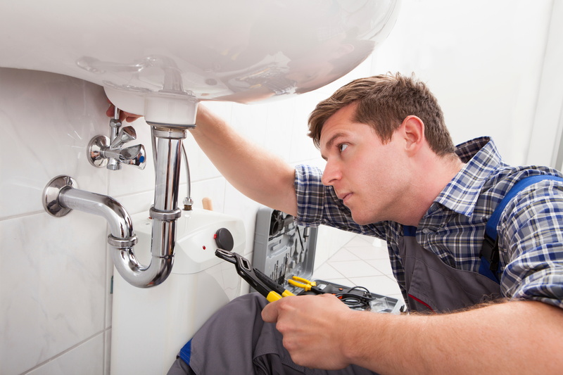 Plumber servicing a sink in Bucks County